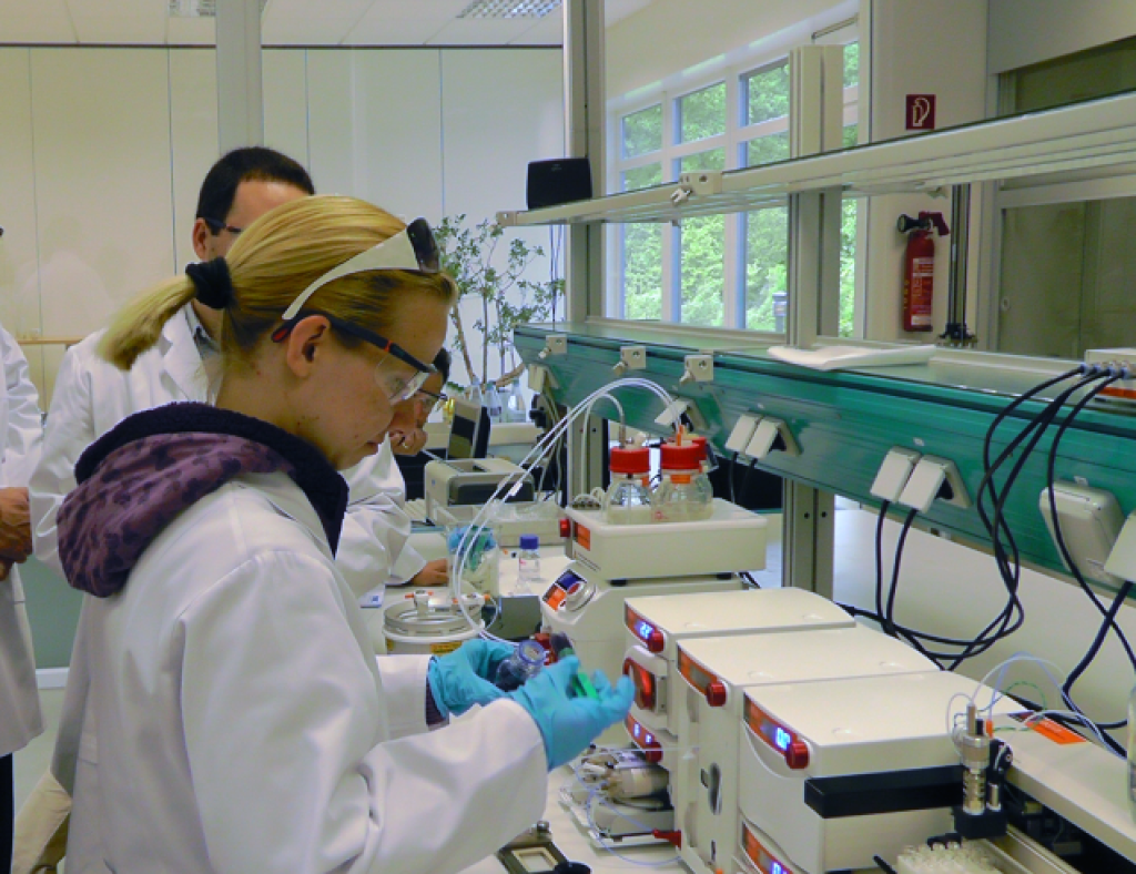 Two chemists in the lab using Syrris Asia syringe pump